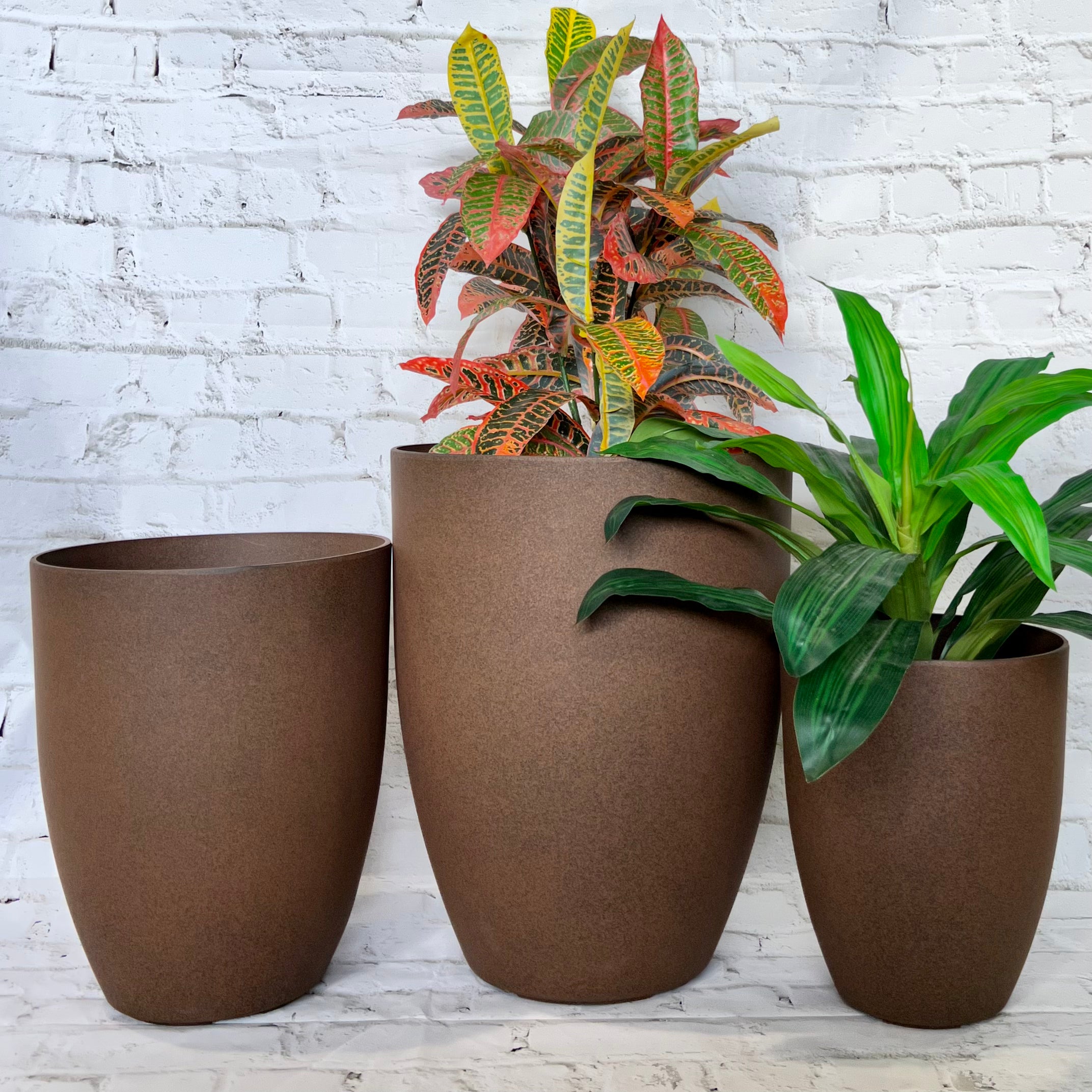 Adam Pot styled outdoors - round smooth lightweight pot with plant